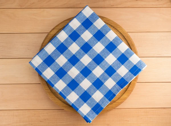 Napkin at cutting board on wood — Stock Photo, Image