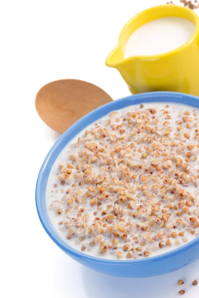 Buckwheat in bowl with milk — Stock Photo, Image