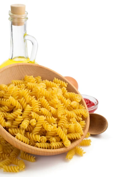 Pasta fusilli in wooden bowl — Stock Photo, Image