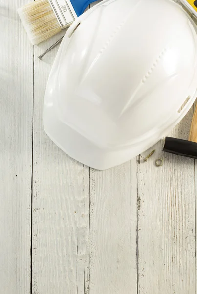 Hardhat and tools on wood — Stock Photo, Image