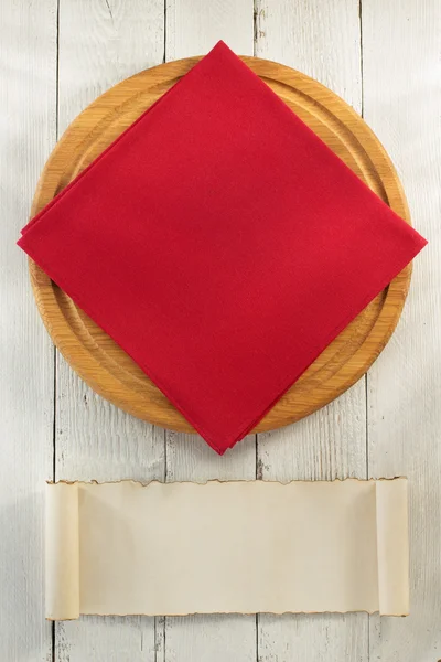 Cloth napkin and cutting board on wood — Stock Photo, Image