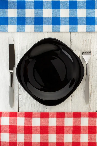 Cloth napkin and plate on wood — Stock Photo, Image