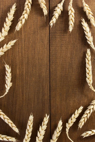 Ears of wheat on wood — Stock Photo, Image