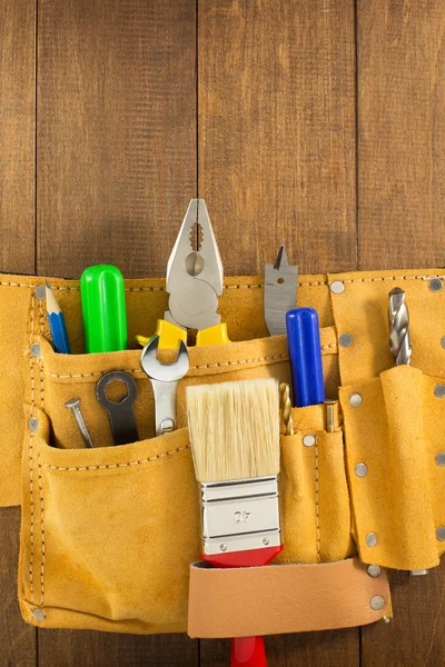 Tools and instruments in belt on wood — Stock Photo, Image