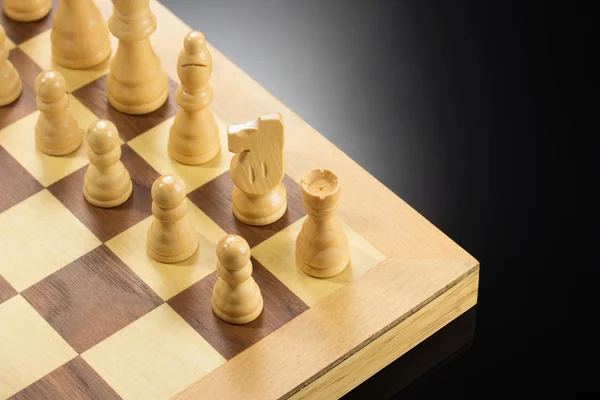 Chess figures and board at black — Stock Photo, Image