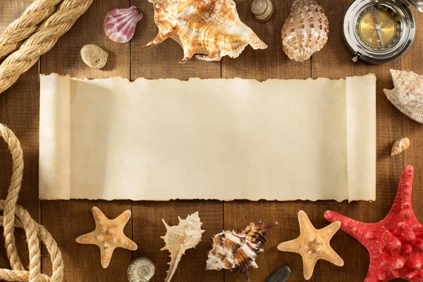 Old paper and seashell on wooden background — Stock Photo, Image