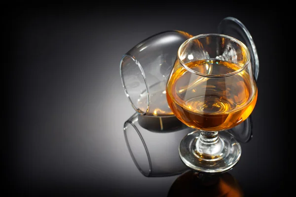 Cognac and  glass  on black — Stock Photo, Image