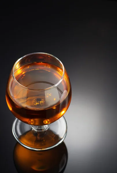 Cognac and  glass  on black — Stock Photo, Image