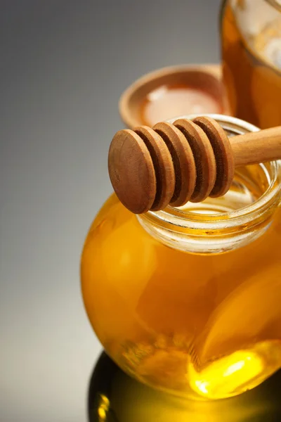 Jarra de vidro de mel no preto — Fotografia de Stock