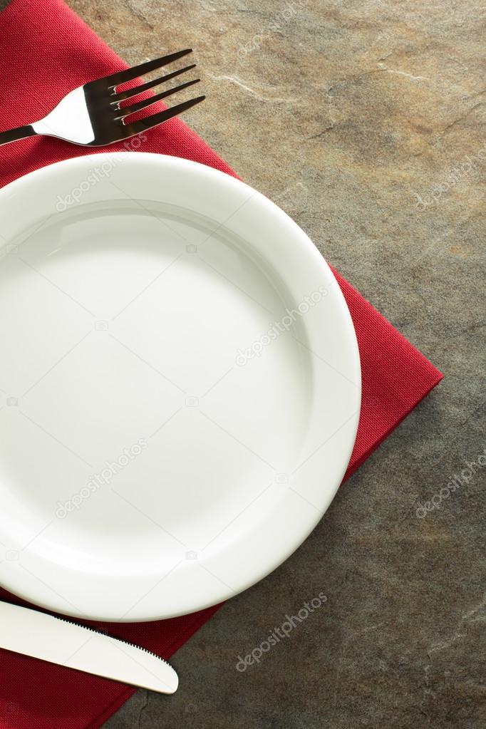 plate, knife and fork on napkin