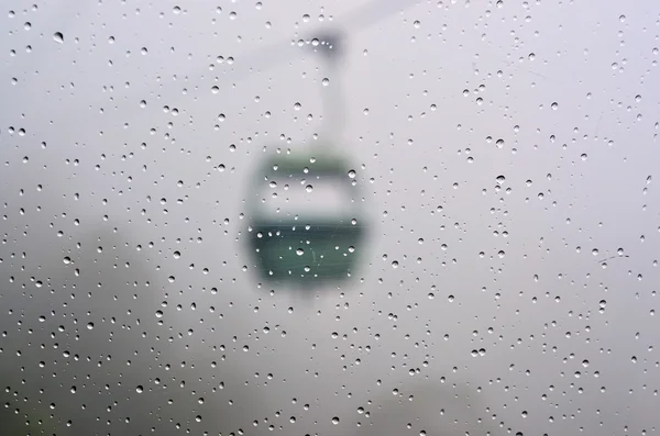 Rain drops on a window glass of a cableway gondola — Stock Photo, Image
