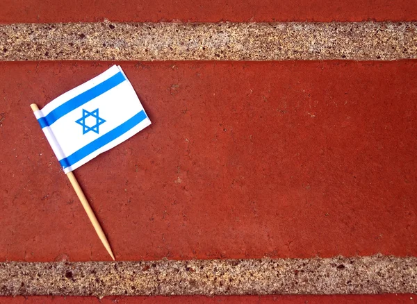 Colocação plana da bandeira de Israel em uma superfície de tijolo — Fotografia de Stock