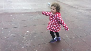 Mutlu küçük kız çalışır ve gökyüzü noktasına