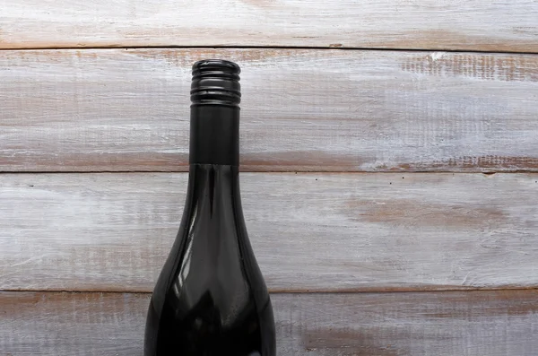 Plat leggen van rode wijn fles op een houten tafel — Stockfoto