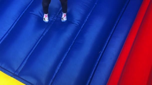 Ung flicka hoppar på bouncing castle — Stockvideo