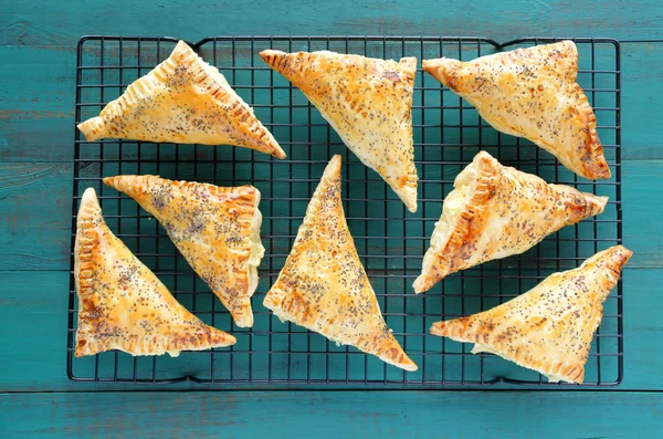 Flat lay of a travy full with cooked Triangular Burekas — Stock Photo, Image