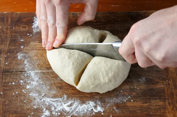 Woman hands cutting dough — Stock Photo, Image