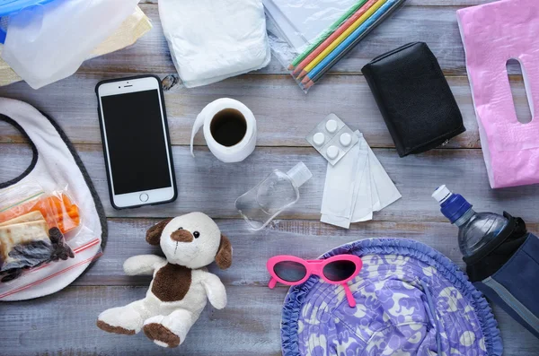 Flat lay view of toddler diaper bag essentials — Stock Photo, Image