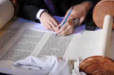 Sofer completing the final letters of sefer Torah clipart