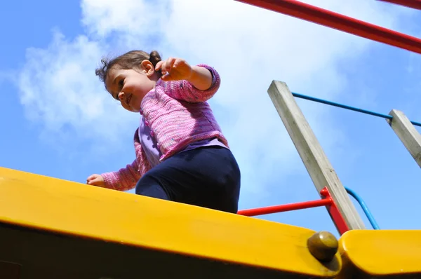 Little girl cross a playground bridge — Stock Photo, Image