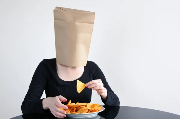 Anonymous woman blindly eats unhealthy food — Stock Photo, Image