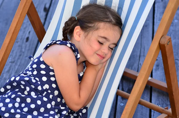 Petit gir dormir dans une chaise d'extérieur — Photo