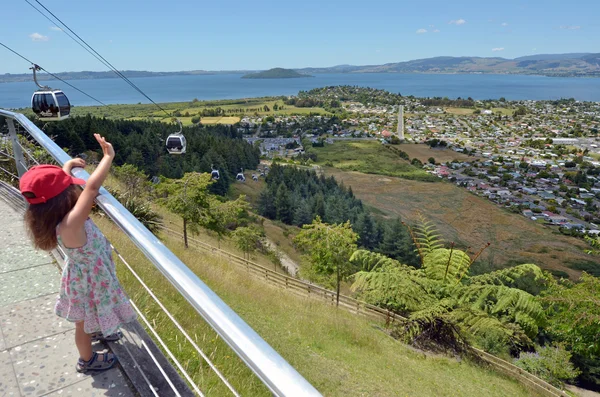 Girl waves to the Skyline Gondola Cableway in New Zealand — Stock Photo, Image