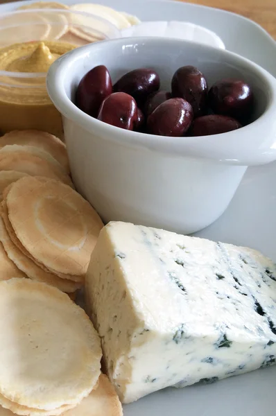 Azeitonas Kalamata, queijo de veia azul, bolachas e húmus — Fotografia de Stock