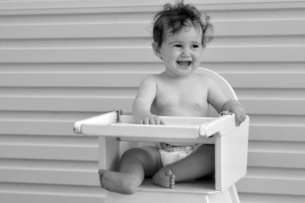 Baby girl on high chair — Stock Photo, Image