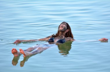 Young Woman floating on the Dead Sea, Israel 