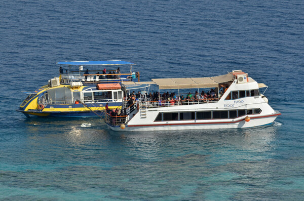 Visitors on a glass boat on Coral Beach Nature Reserve in Eilat,