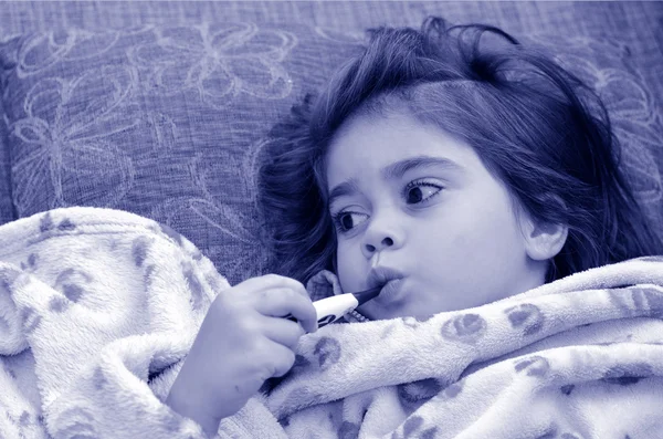 Ill girl child with thermometer in mouth — Stock Photo, Image