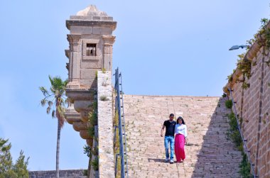 Arab couple visit at the walls of Akko clipart