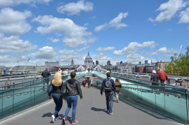 Pedestrian cross over the Millennium Bridge in London, UK