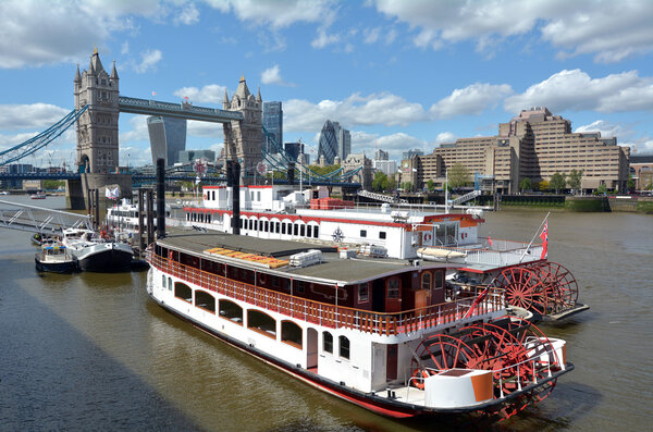LONDON -  MAY 13 2015:P.S. Elizabethan against the Tower Bridge in London,UK. It is one of the most luxurious boats for hire on the River Thames in London choice of royalty and the rich and famous.