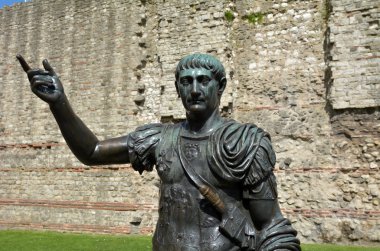 Statue of Trajan in front of a section of the Roman wall, Tower 