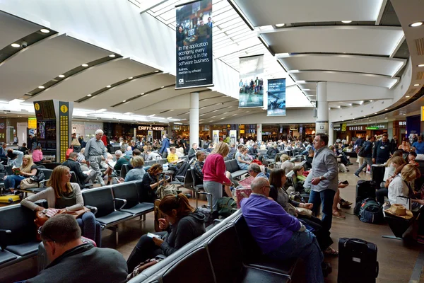 Passengers in Heathrow Airport in London, UK — Stok fotoğraf
