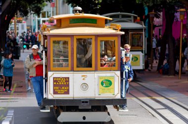Passengers riding on Powell-Hyde line cable car in San Francisco clipart