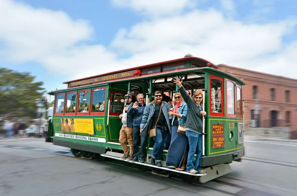 Passengers riding on Powell-Hyde line cable car in San Francisco — стокове фото
