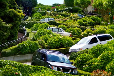 Cars drive down Lombard Street switchback in San Francisco CA clipart