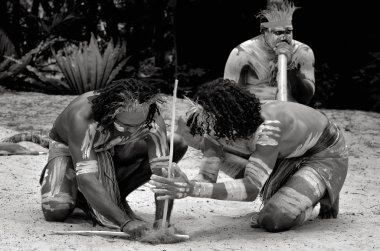 Yugambeh Aboriginal warriors men demonstrate fire making craft during Aboriginal culture show in Queensland, Australia. clipart
