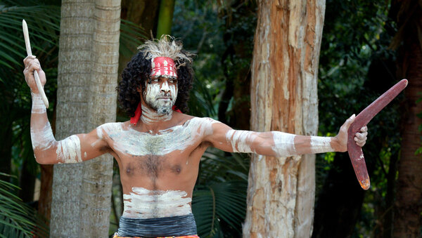 Aboriginal warrior throwing boomerang during cultural show in Queensland, Australia.