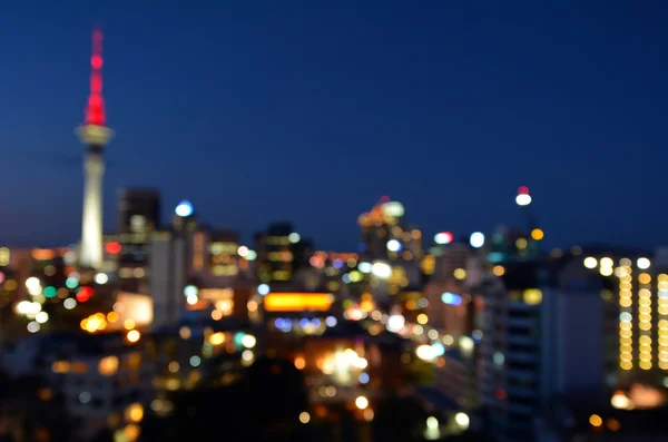 Bokeh achtergrond van financiële centrum skyline van Auckland bij nacht — Stockfoto