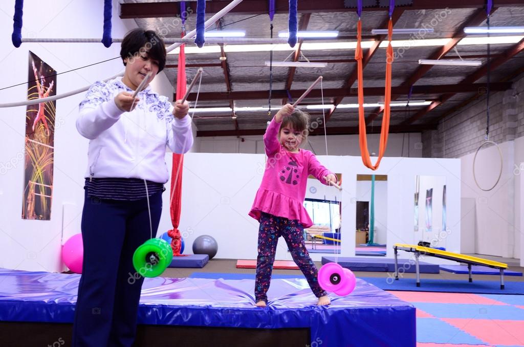 Little child learn circus skills of Yo-yo from circus instructor