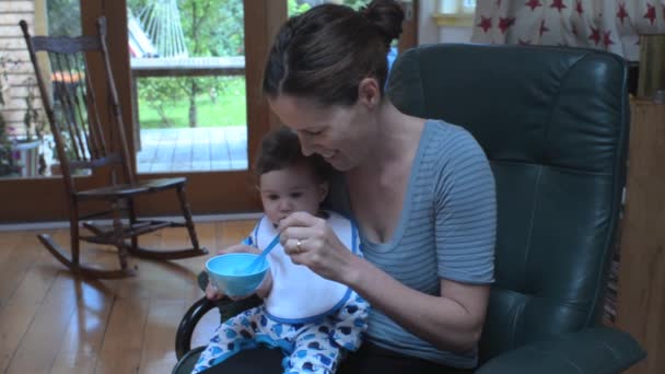 Infant baby eat solid food for the first time 01 — Vídeo de stock