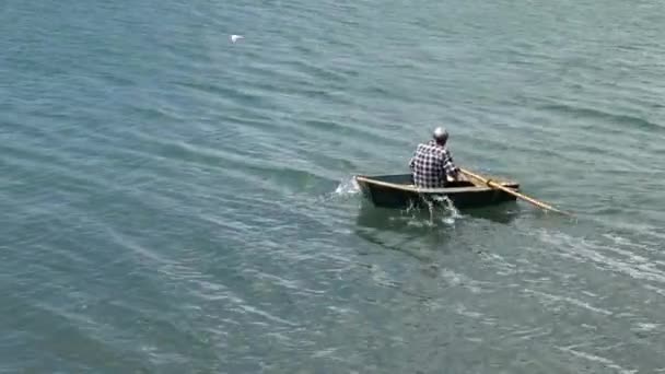 Man row a row boat at sea — Stock Video © lucidwaters #82323100