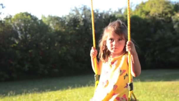 Caucasian little girl playing swing — Stock Video