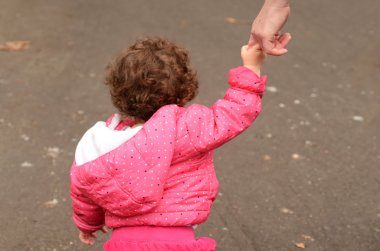 Child hold hands with his mother