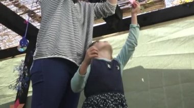 Jewish woman and child decorating Sukkah for the Jewish festival of Sukkot