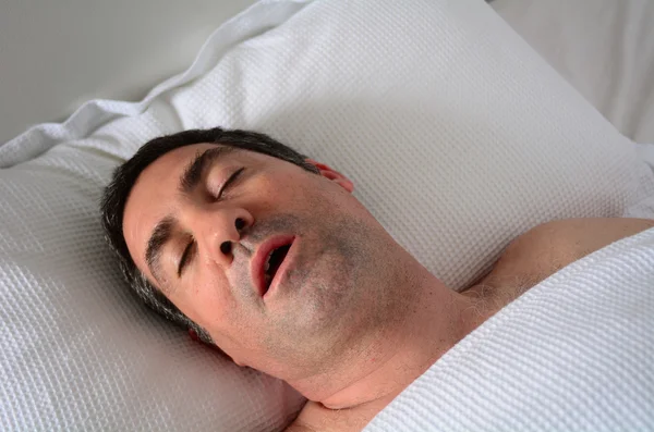 Man snoring in bed — Stock Photo, Image